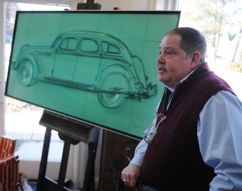 Estates and Appraisals Manager Rick Daley shows a cast polyurethene lithograph "Profile Airflow" by Claes Oldenburg at the estate auction preview at Black Rock Galleries